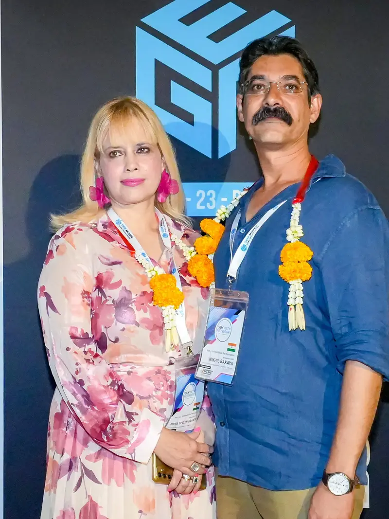 Priya and Nikhil Bakaya at GEM Bangkok in November 2025, both wearing marigold garlands.